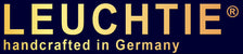 A dark navy banner with large gold LEUCHTIE text, a gold 'Made in Germany' seal on the left, and a Dalmatian dog on the right wearing a yellow collar.